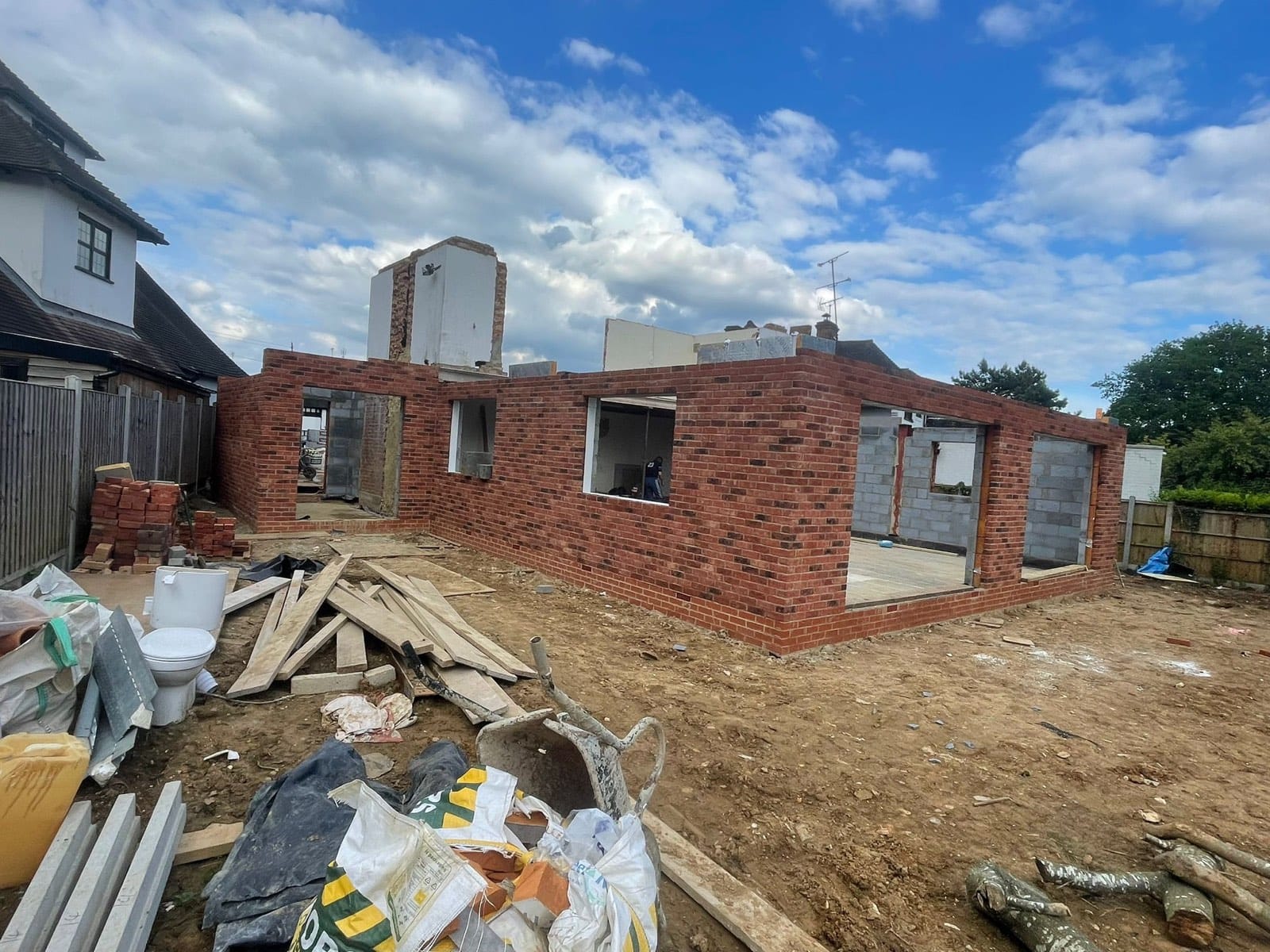 New-build brick-and-block shell with window and door openings, on a residential plot in Barnet.